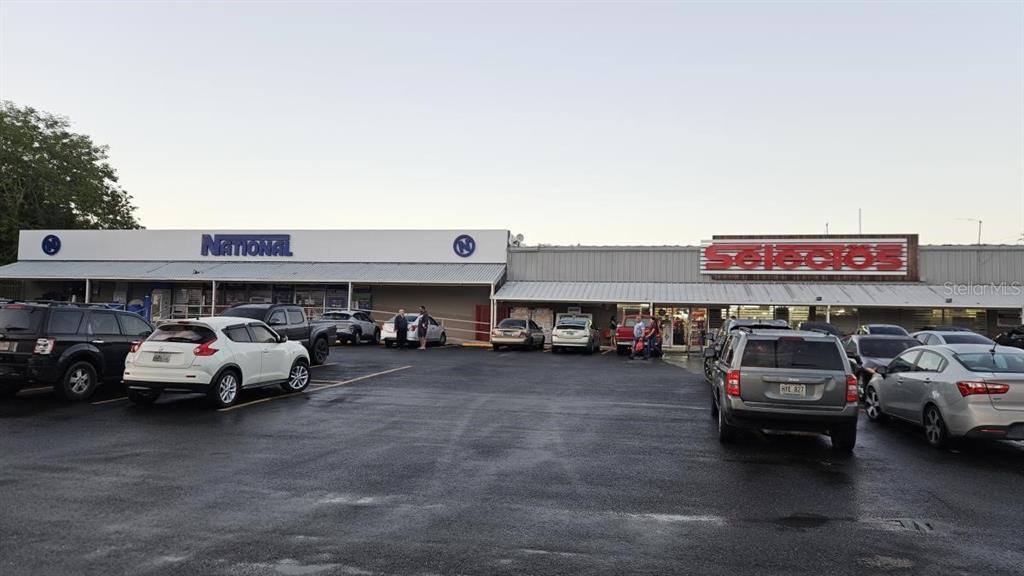 A parking lot sits in front of a commercial building with National and Selectos storefronts — 115 STATE ROAD PR - 115, AGUADA, PR