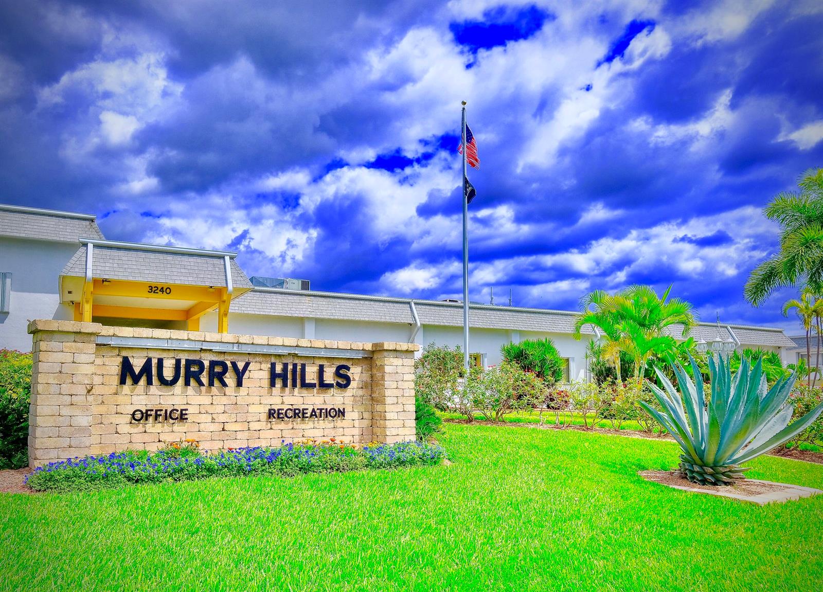 A brick sign for Murry Hills stands in front of a building under a cloudy sky — 2920 Cynthia Lane # 202, FL 33461, FL