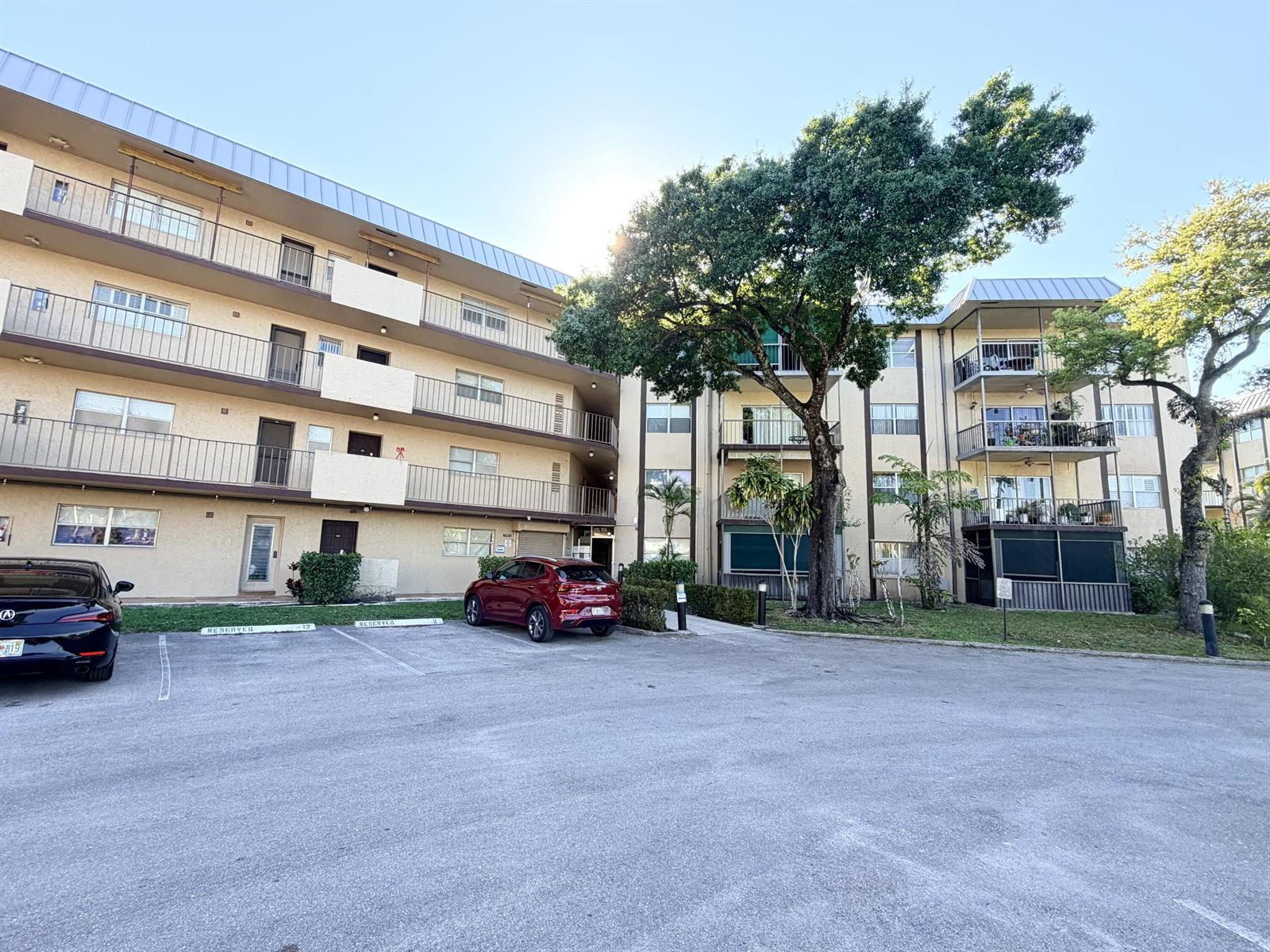 A multi-story apartment building with balconies and a parking lot in the foreground — 6260 S Falls Cir Drive # 201, Lauderhill FL 33319, LAUDERHILL, FL