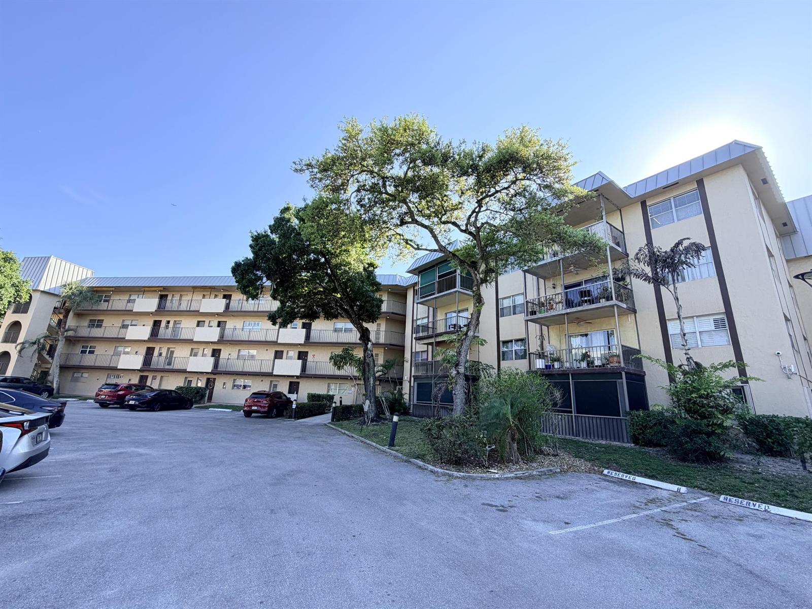 A hallway with wood-look flooring leads to a living area with a view of water — 6260 S Falls Cir Drive # 201, Lauderhill FL 33319, LAUDERHILL, FL