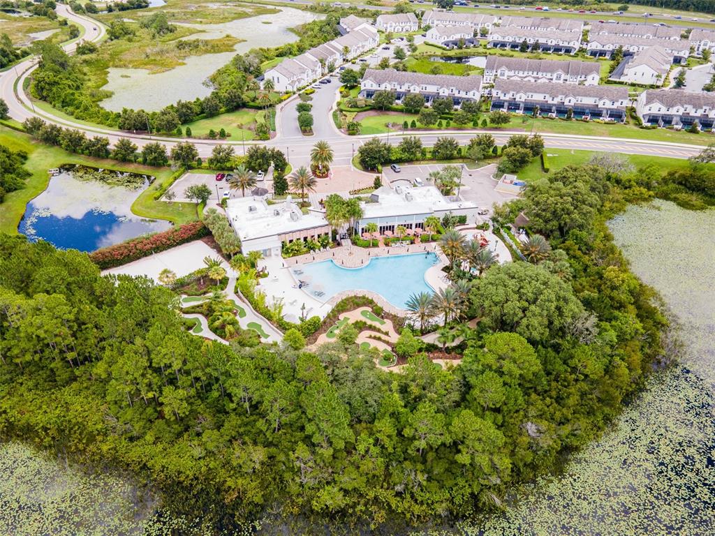 An aerial view of a community clubhouse with a swimming pool and miniature golf course — 1038 PLANTATION LANE, DAVENPORT, FL