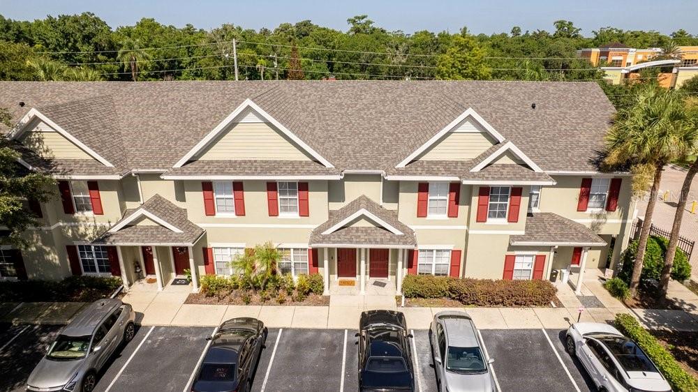 An aerial view shows a multi-unit townhouse building with a parking lot in front — 10020 REGENT PARK DRIVE UNIT 2405, ORLANDO, FL