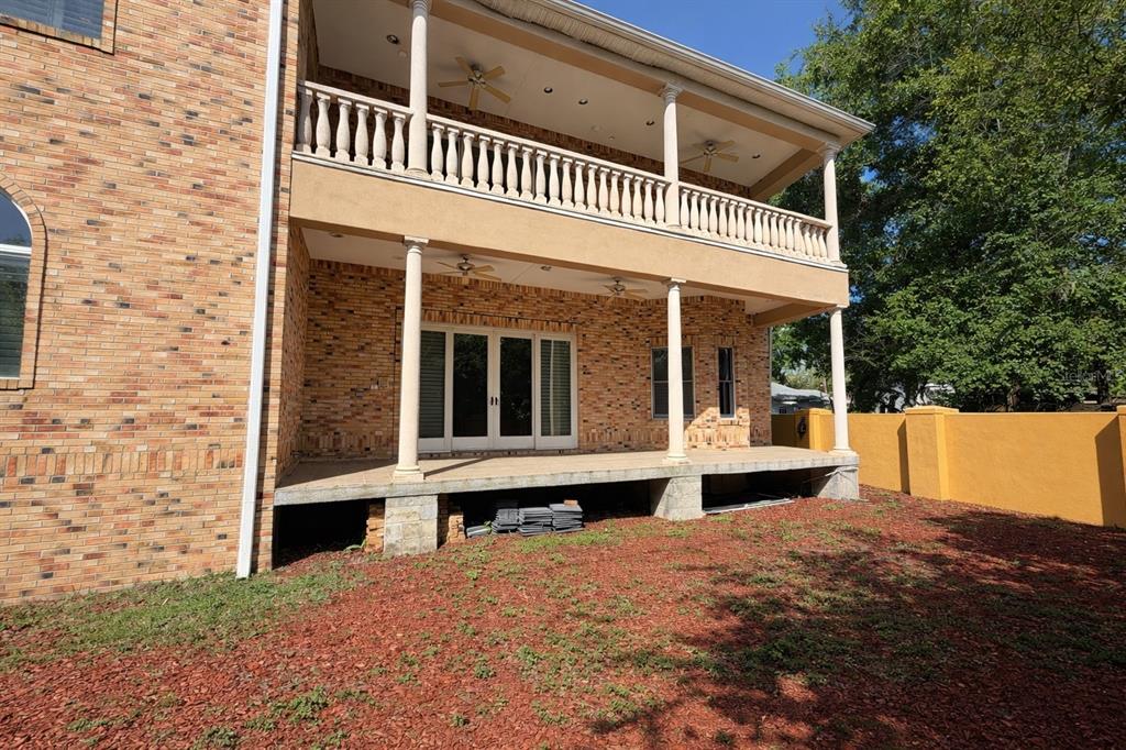 The exterior of a two-story brick house features a covered patio and a second-story balcony — 441 LUCERNE AVENUE, TAMPA, FL