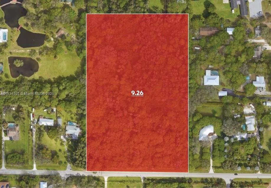 This aerial view shows a large, rectangular, wooded plot of land highlighted in red — 2140 Bell Ave, Fort Pierce FL 34982, FORT PIERCE, FL