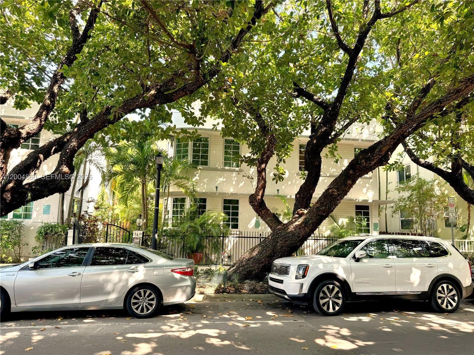 A white two-story building is partially obscured by large trees and parked cars — 349 Meridian Ave # B202, Miami Beach FL 33139, MIAMI BEACH, FL