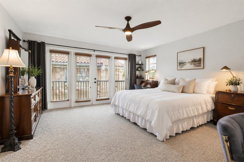 A bedroom features a king bed, wooden furniture, a ceiling fan, and glass balcony doors — 208 VALENCIA CIRCLE, ST PETERSBURG, FL