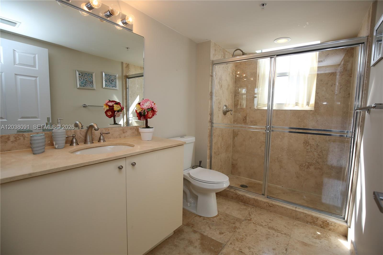 A bathroom features a beige vanity, a toilet, and a glass-enclosed walk-in shower with tile — 3232 SW 22nd Ter # 1510, Miami FL 33145, MIAMI, FL
