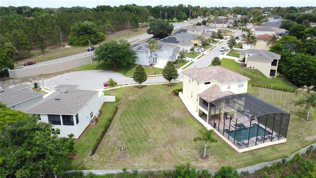 An aerial view shows two houses with a vacant lot between them in a neighborhood — 354 CHEROKEE AVE, HAINES CITY, FL