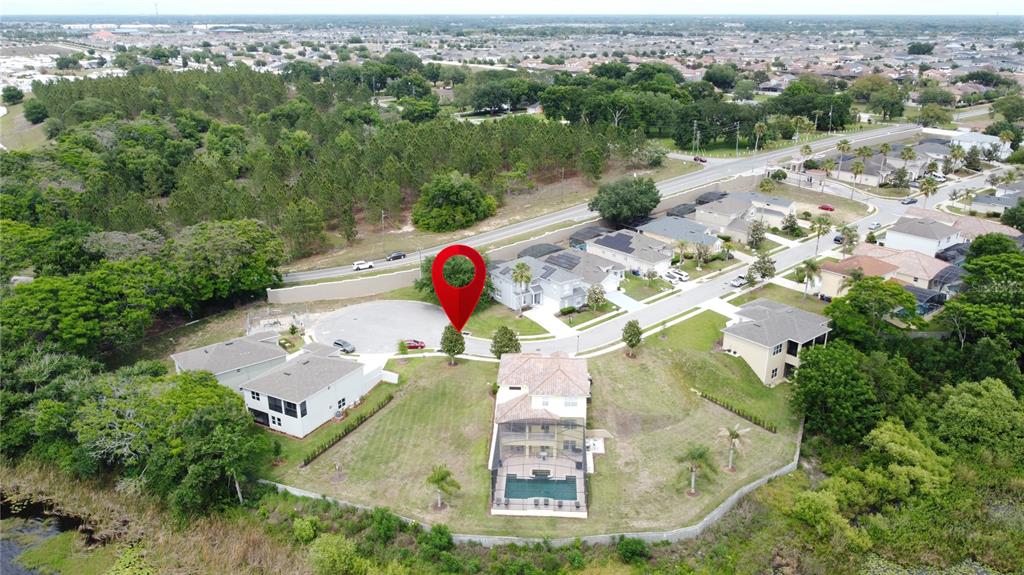 An aerial view shows a vacant residential lot marked by a pin in a neighborhood — 354 CHEROKEE AVE, HAINES CITY, FL