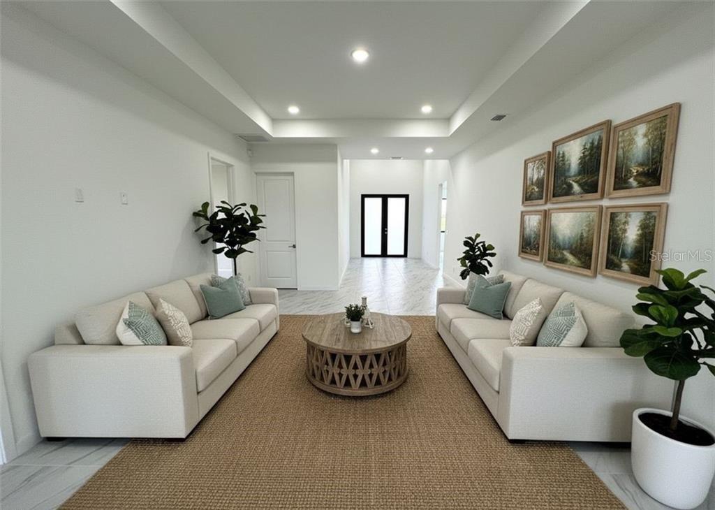 A living room features two beige sofas, a round wooden coffee table, and framed artwork — 1247 KISMET PARKWAY W, CAPE CORAL, FL