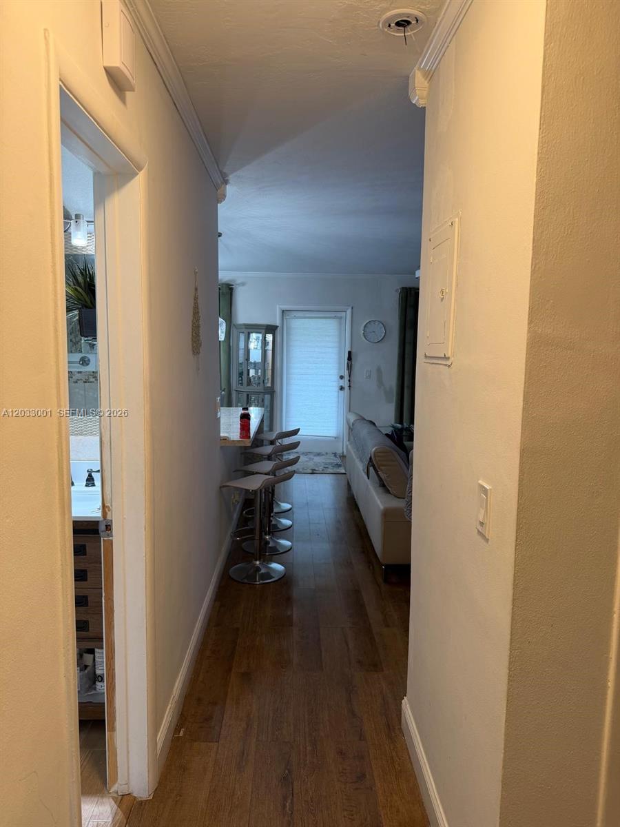 A hallway leads to a living area with a breakfast bar and stools — 500 Layne Blvd # 12, Hallandale Beach FL 33009, HALLANDALE BEACH, FL