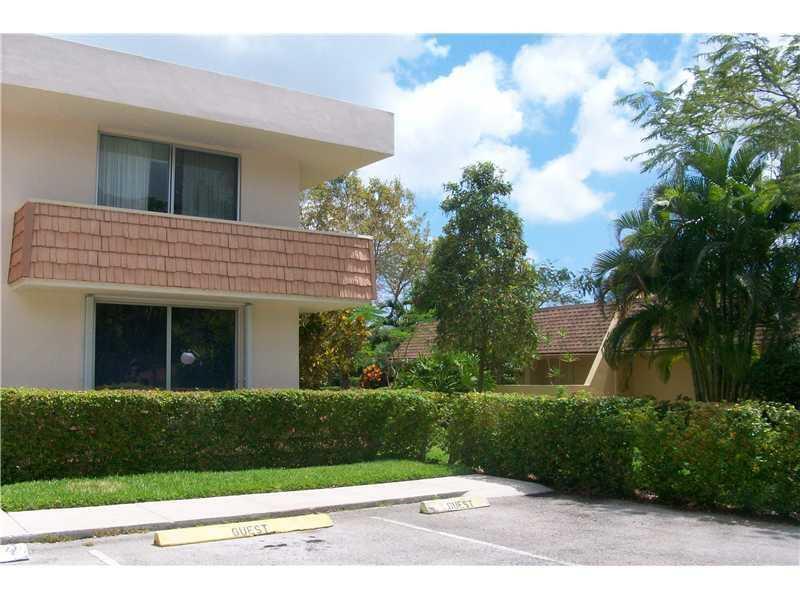A two-story apartment building exterior with guest parking spaces in the foreground — 4031 N Cypress Drive # 101, Pompano Beach FL 33069, POMPANO BEACH, FL