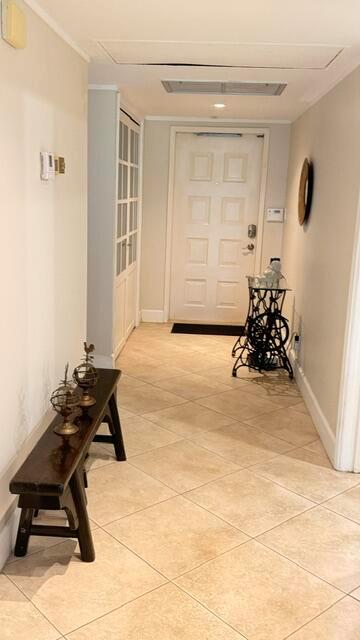 A hallway with a wooden bench, a vintage sewing machine table, and tiled flooring — 4031 N Cypress Drive # 101, Pompano Beach FL 33069, POMPANO BEACH, FL