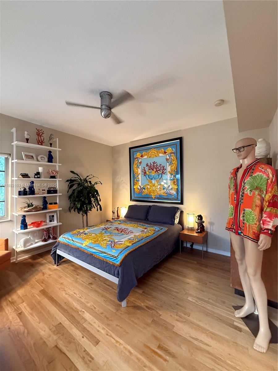 A bedroom features a bed with a patterned throw, a white shelving unit, and a mannequin — 1600 Michigan Ave # 1, Miami Beach FL 33139, MIAMI BEACH, FL