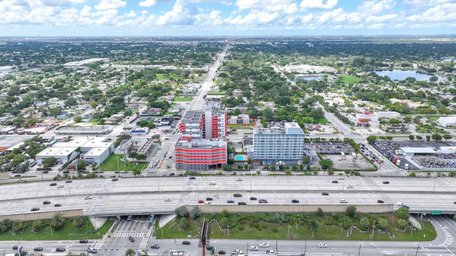 Aerial view of a multi-story building complex situated next to a major highway — 734 NW 80th Street, Miami FL 33150, MIAMI, FL