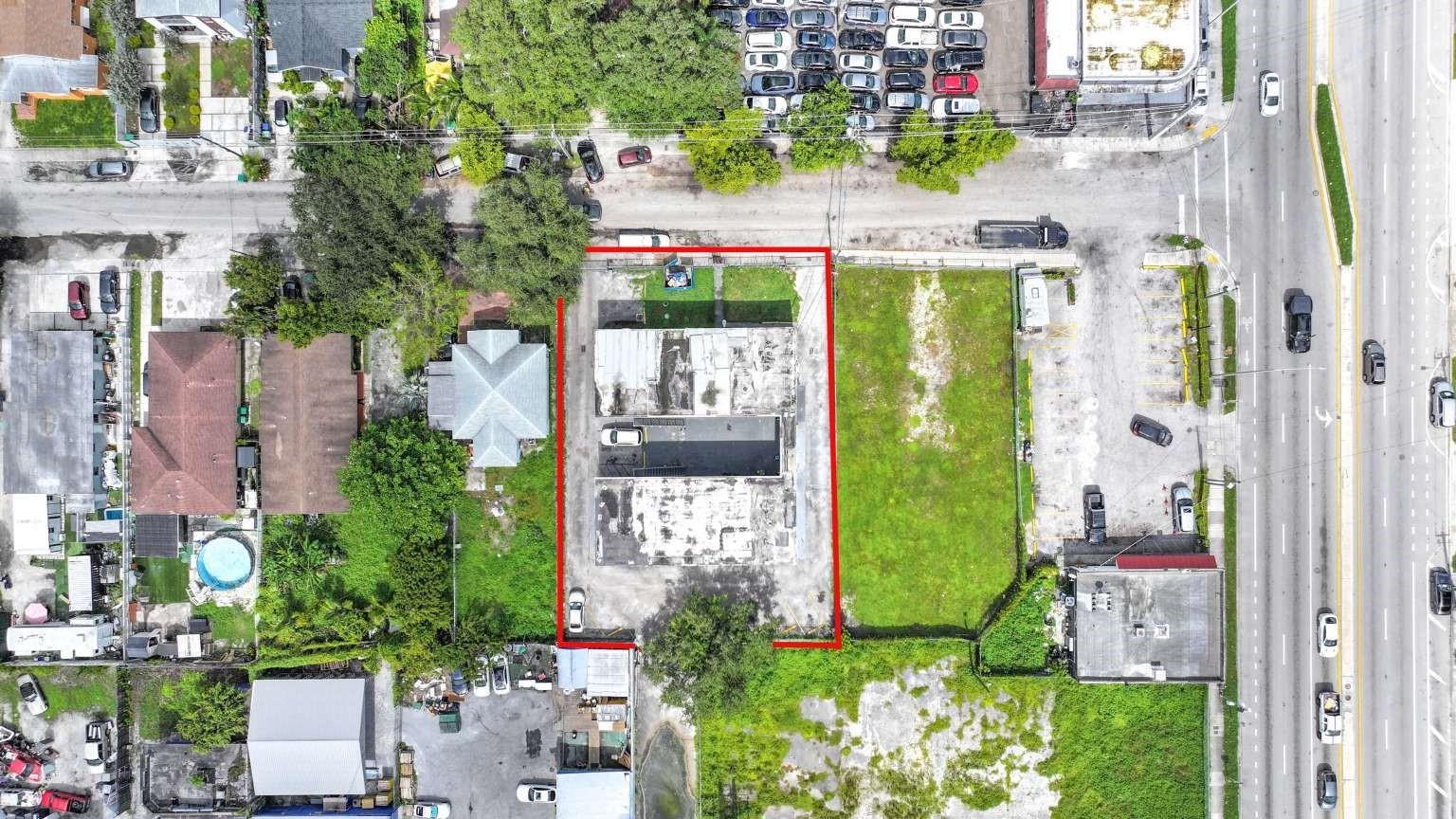 An aerial view shows a rectangular commercial property outlined in red with a flat-roofed building — 734 NW 80th Street, Miami FL 33150, MIAMI, FL
