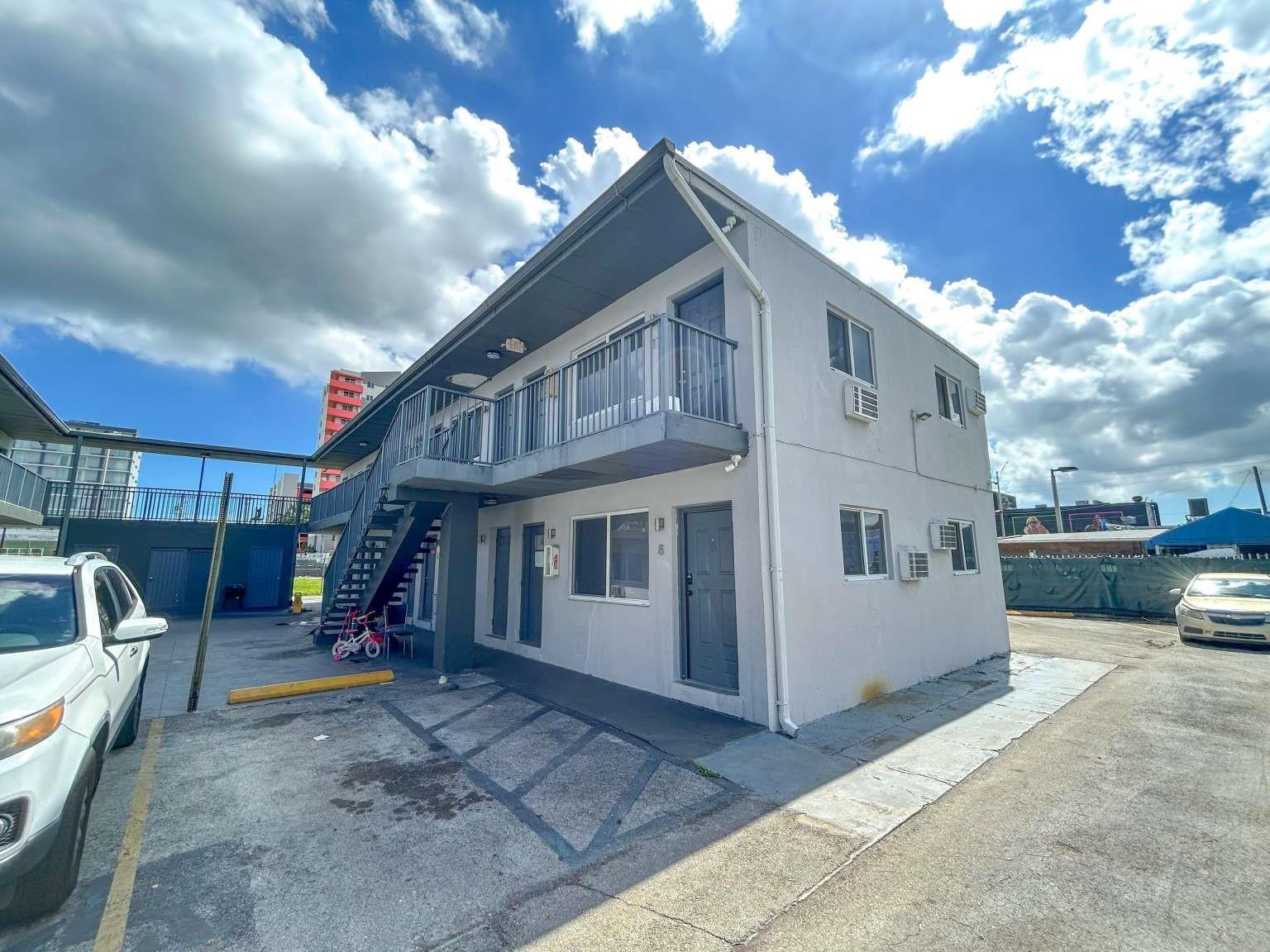 A two-story apartment building with exterior stairs, a balcony, and a paved parking lot — 734 NW 80th Street, Miami FL 33150, MIAMI, FL
