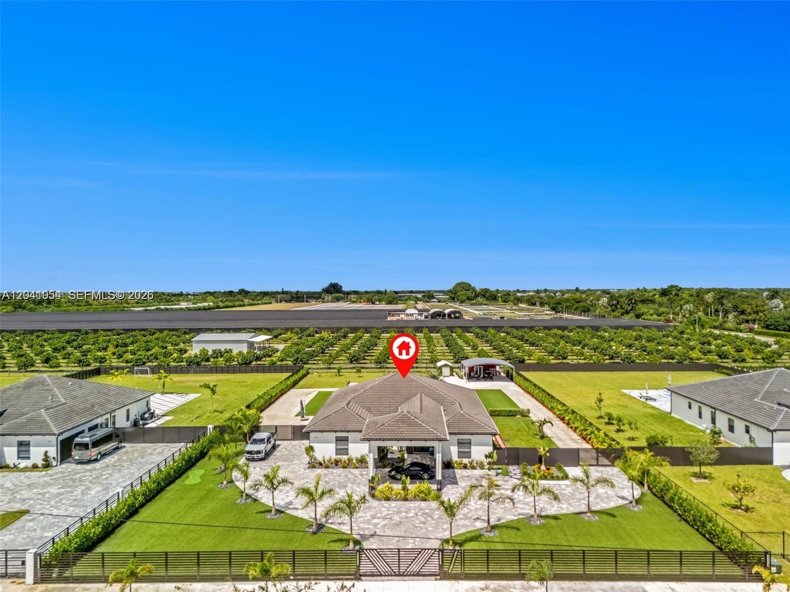 An aerial view shows a single-story house with a paved driveway and surrounding lawn — 18261 SW 224th St, Miami FL 33170, MIAMI, FL