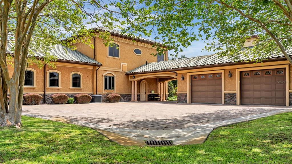 An aerial view shows a large, two-story stucco house with a tile roof and driveway — 5503 DOWNING STREET, DOVER, FL