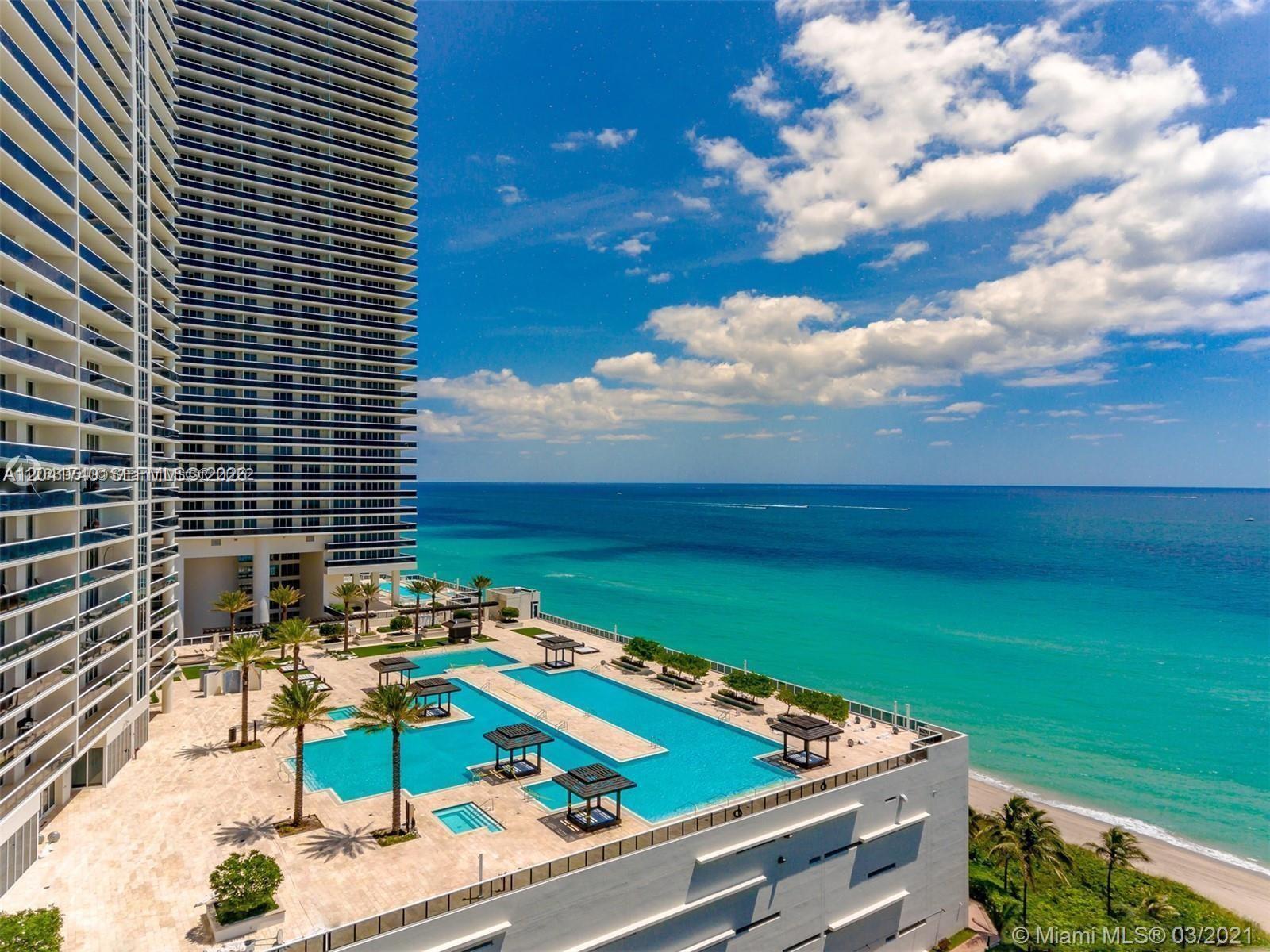 An aerial view shows a high-rise building with a large pool deck overlooking the ocean — 1830 S Ocean Dr # 3707, Hallandale Beach FL 33009, HALLANDALE BEACH, FL