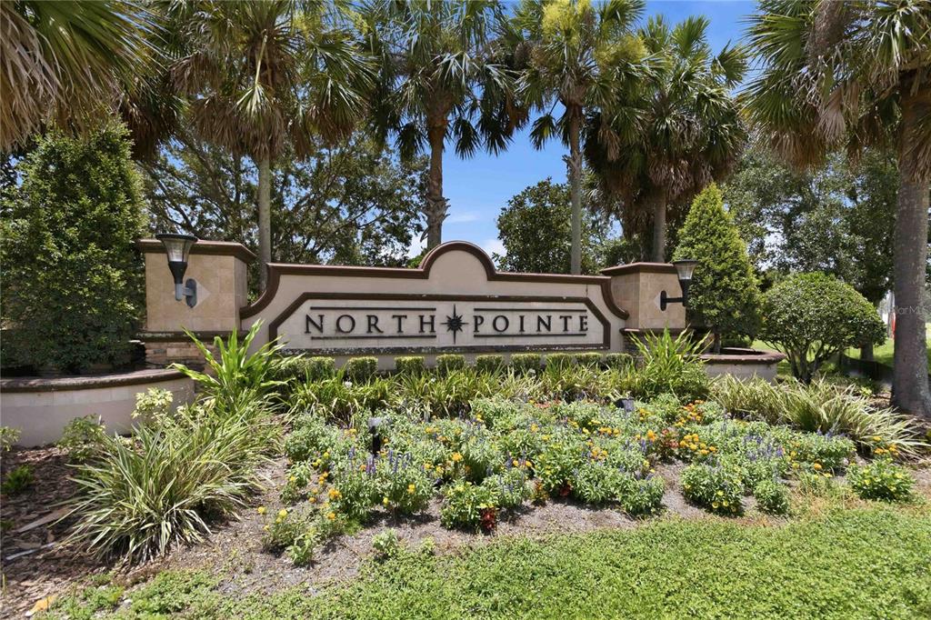 A stone monument sign for North Pointe stands in front of palm trees and landscaping — 4355 SUMMER BREEZE WAY, KISSIMMEE, FL