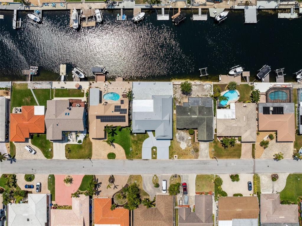 A single-story house with a light-colored exterior, stone accents, and a two-car garage — 5041 CABRILLA COURT, NEW PORT RICHEY, FL