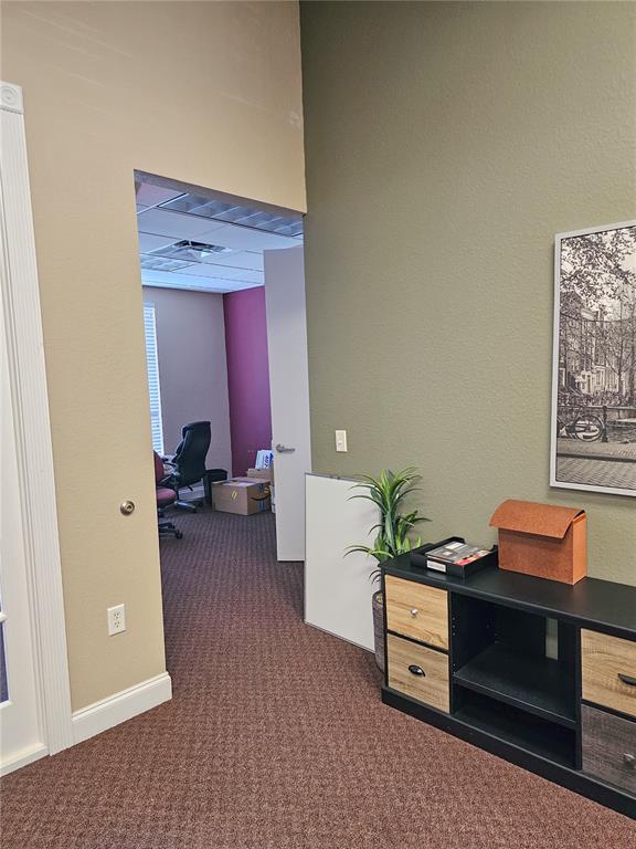 An office interior features a doorway leading to a second room with carpeted flooring — 422 S ALAFAYA TRAIL UNIT 30, ORLANDO, FL
