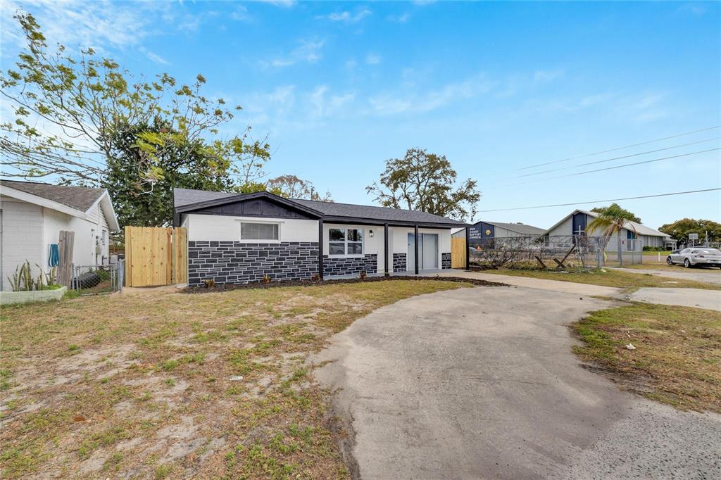 A single-story house with a black and white exterior and a curved concrete driveway — 4012 VALENCIA DRIVE, NEW PORT RICHEY, FL