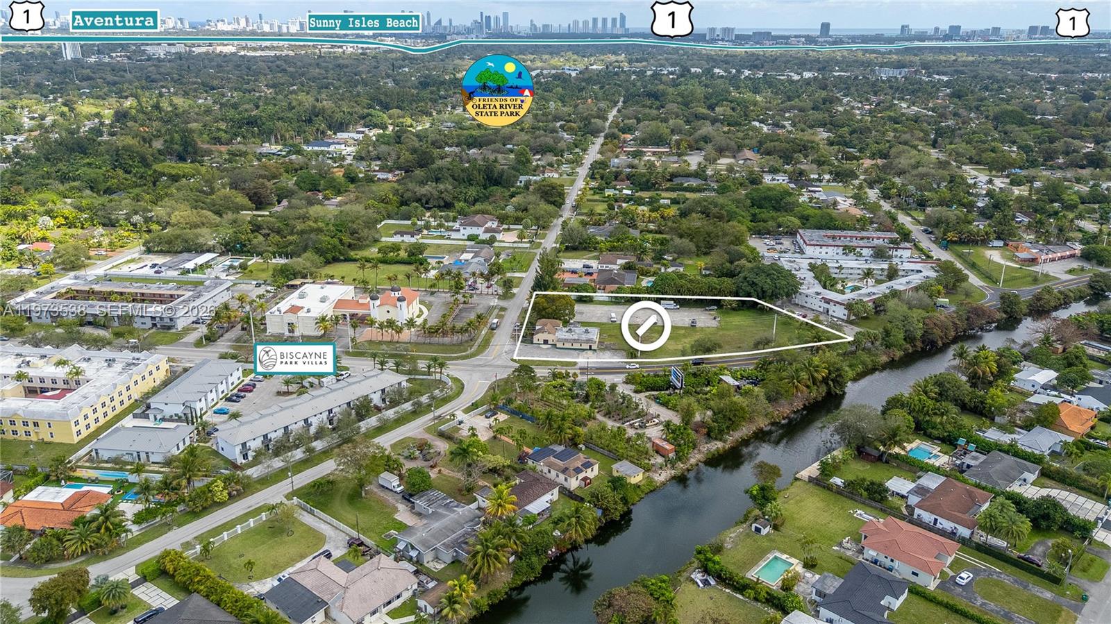 An aerial view shows a vacant lot with a small building next to a canal — 15343 NW 2nd Ave, Miami FL 33169, MIAMI, FL