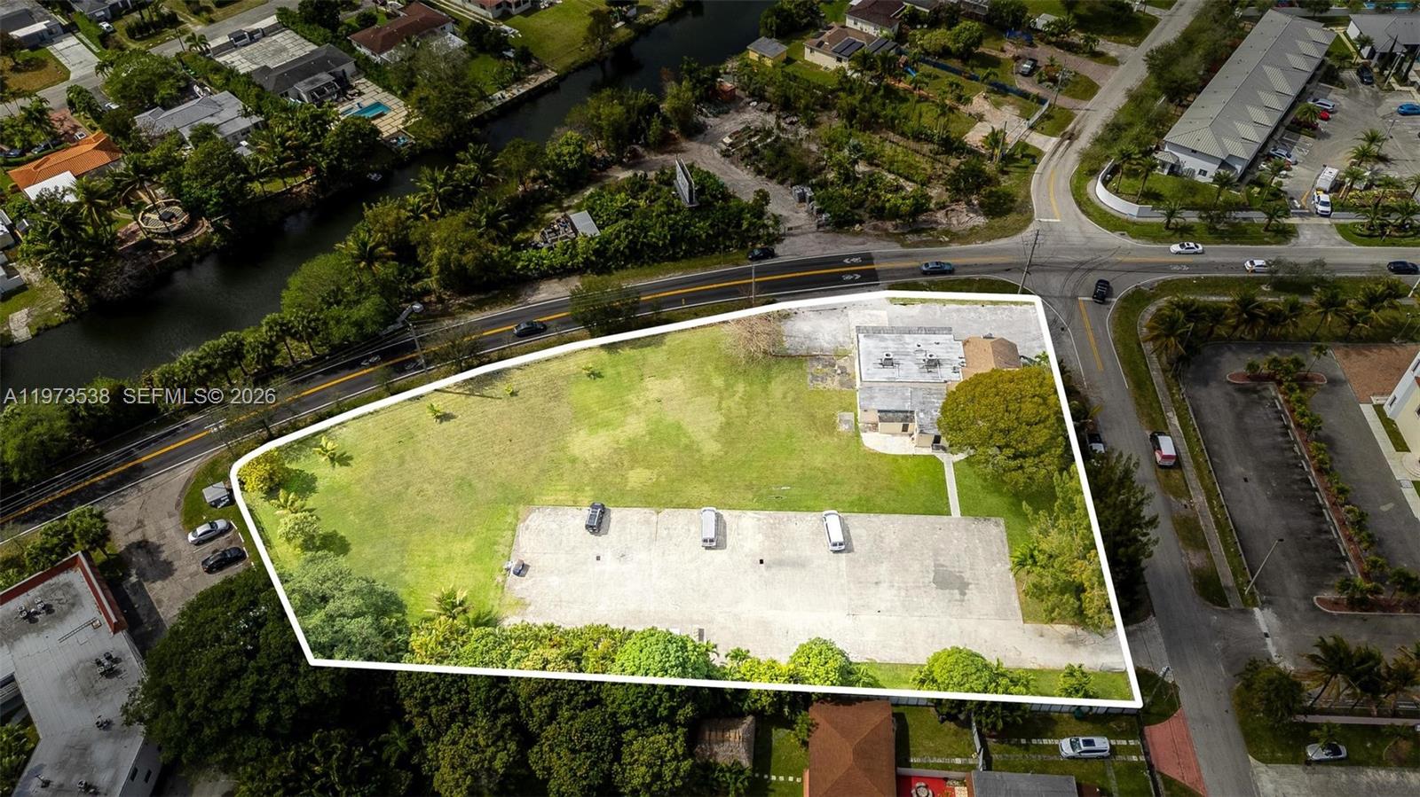 An aerial view shows a large lot with a building, parking area, and surrounding vegetation — 15343 NW 2nd Ave, Miami FL 33169, MIAMI, FL
