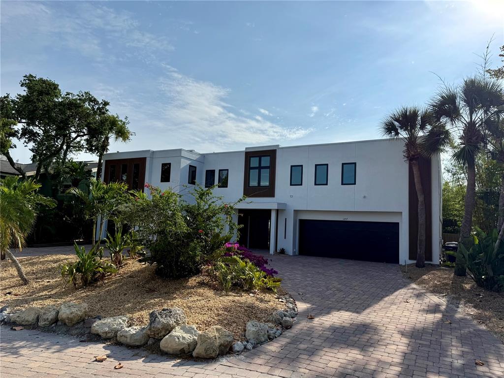A modern two-story house with a white exterior, flat roof, and a paved driveway — 1257 TREE BAY LANE, SARASOTA, FL