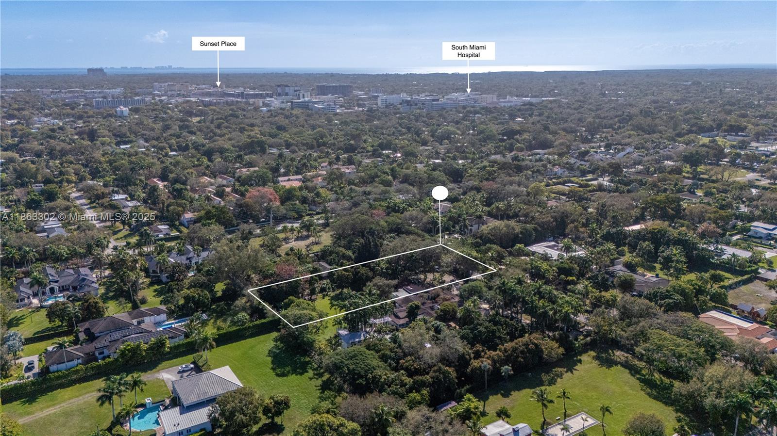 An aerial view shows a large, rectangular residential lot outlined in white amidst lush greenery — 6767 SW 67th St, South Miami FL 33143, SOUTH MIAMI, FL