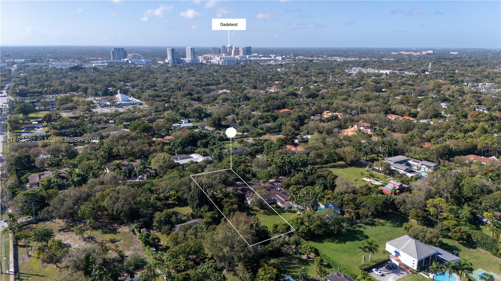 An aerial view shows a residential property lot outlined in white amidst a wooded neighborhood — 6767 SW 67th St, South Miami FL 33143, SOUTH MIAMI, FL