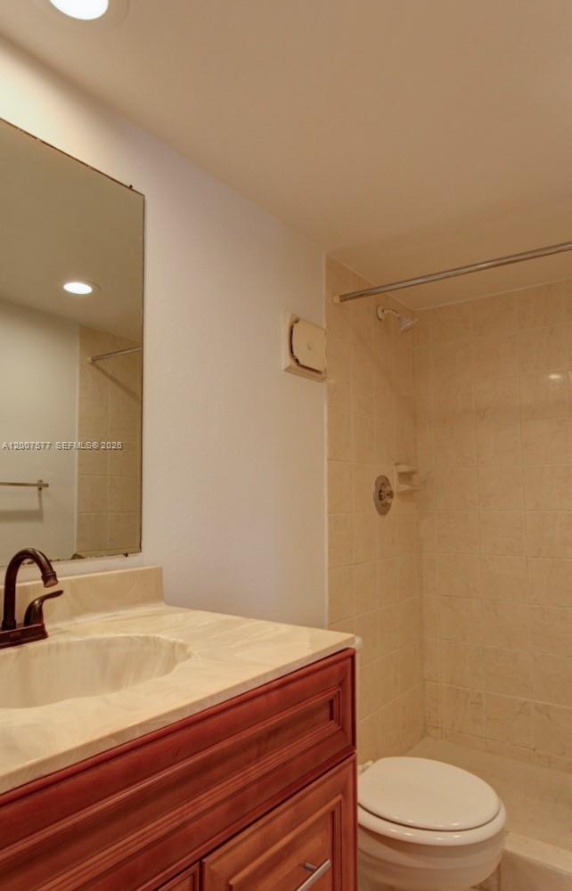 A bathroom features a vanity with a stone countertop, a mirror, and a tiled shower — 8020 SW 17th Pl # 5, Davie FL 33324, DAVIE, FL