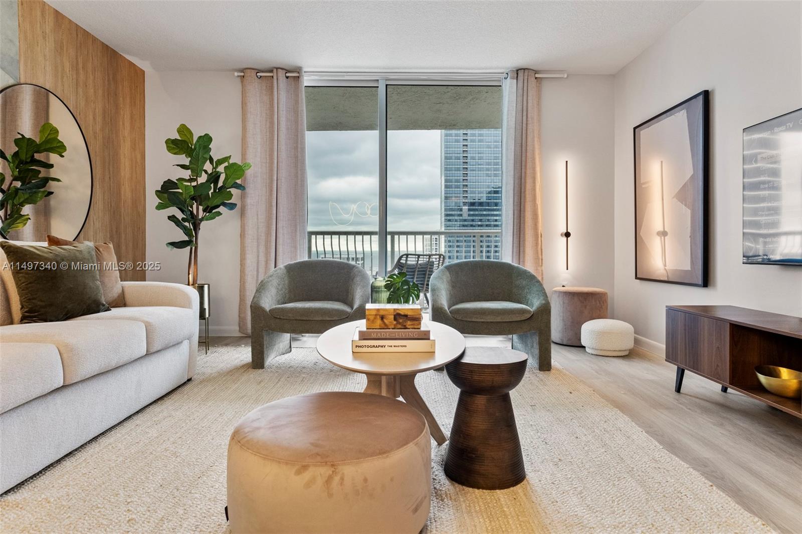 A modern living room features a sofa, two armchairs, a coffee table, and a balcony view — 1200 Brickell Bay Dr # 3619, Miami FL 33131, MIAMI, FL
