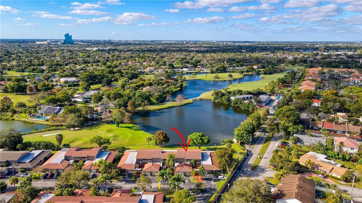 An aerial view shows a multi-unit residential building situated next to a lake and golf course — 103 St Andrews Road, Hollywood FL 33021, HOLLYWOOD, FL