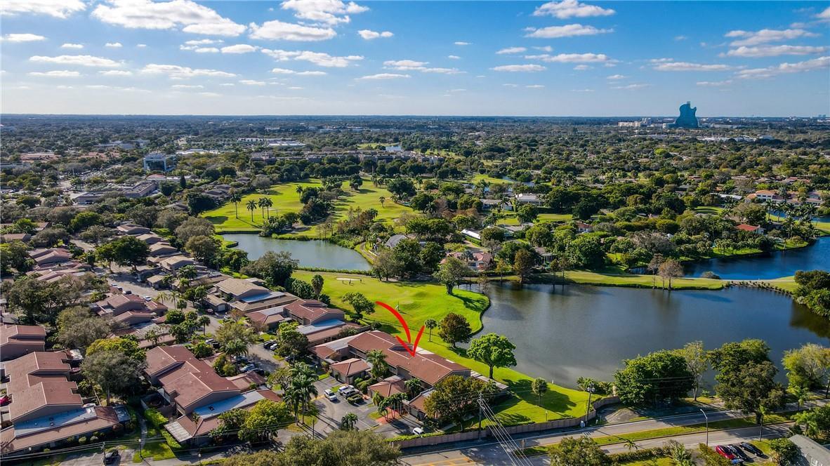 An aerial view shows a residential complex situated next to a lake and golf course — 103 St Andrews Road, Hollywood FL 33021, HOLLYWOOD, FL