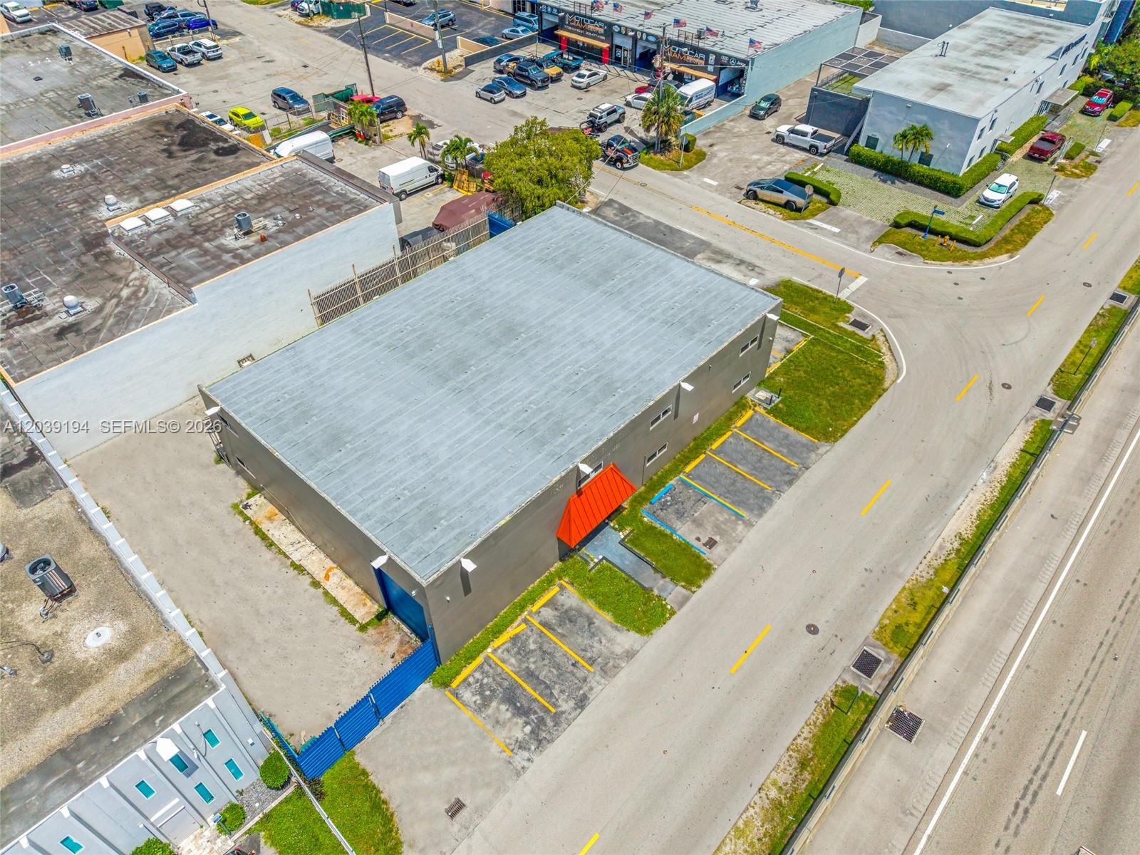 An aerial view shows a rectangular commercial building with a flat roof and parking spaces — 5280 NW 77th Ct, Doral FL 33166, DORAL, FL
