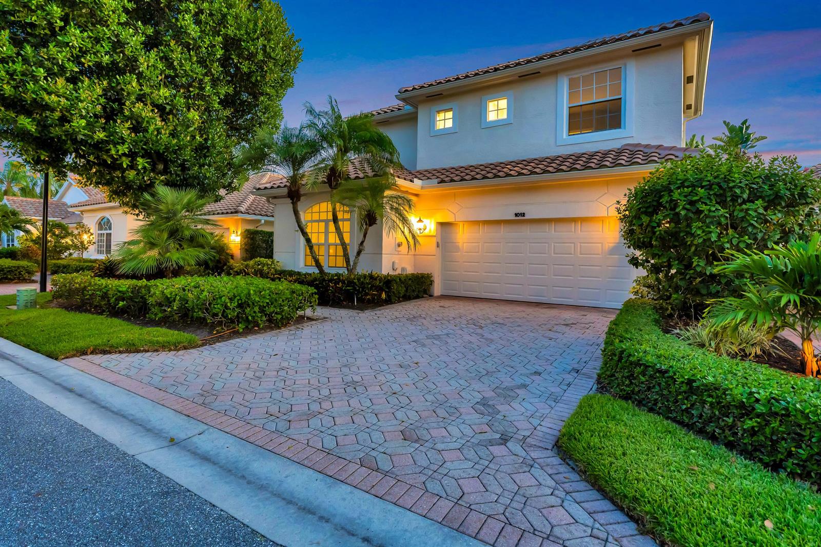 A two-story house with a tiled roof, white stucco exterior, and a paved driveway — 1012 Diamond Head Way, Palm Beach Gardens FL 33418, PALM BEACH GARDENS, FL