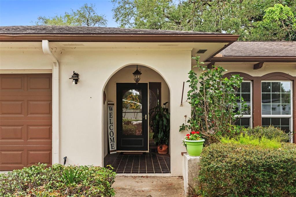 A single-story house with a brown roof, stucco exterior, and a two-car garage — 4405 W MELROSE AVENUE, TAMPA, FL