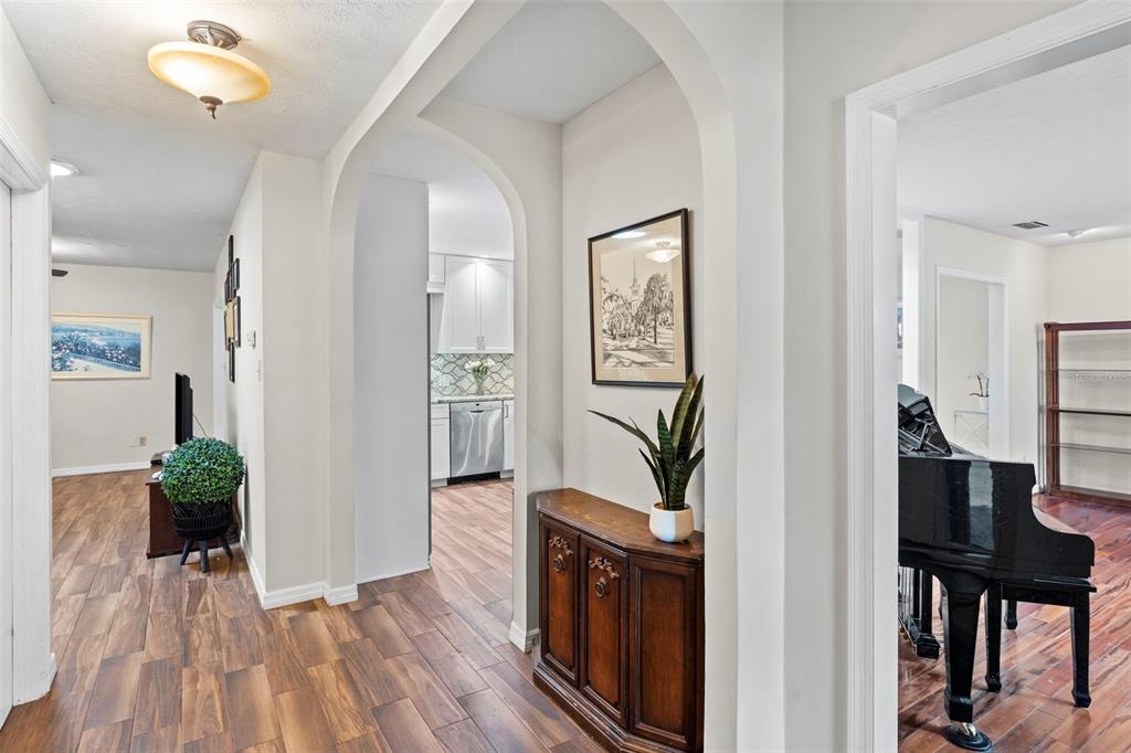 A single-story house with a brown garage door, arched entryway, and a large oak tree — 4405 W MELROSE AVENUE, TAMPA, FL