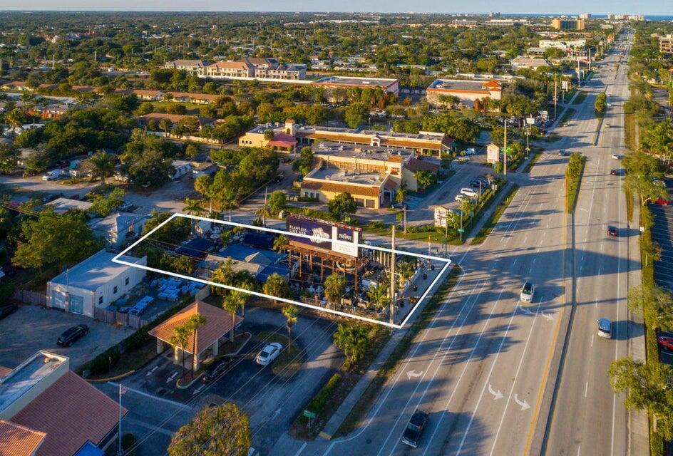 An aerial view shows a commercial property with a billboard and outdoor seating area — 11555 Us-1, North Palm Beach FL 33408, NORTH PALM BEACH, FL