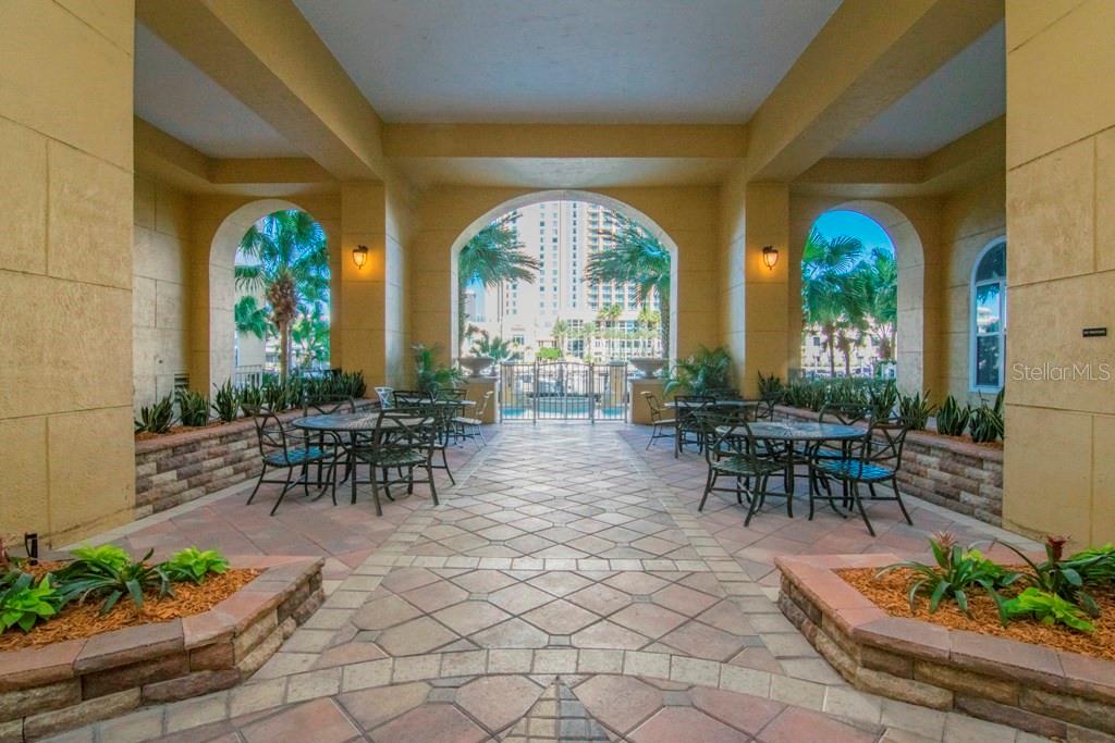 A covered outdoor patio features arched openings, stone tile flooring, and metal patio furniture — 700 S HARBOUR ISLAND BOULEVARD UNIT 535, TAMPA, FL