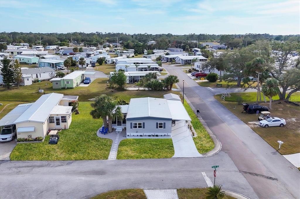 An aerial view of a residential neighborhood featuring several manufactured homes and paved streets — 6401 FLORAL COURT, NORTH PORT, FL