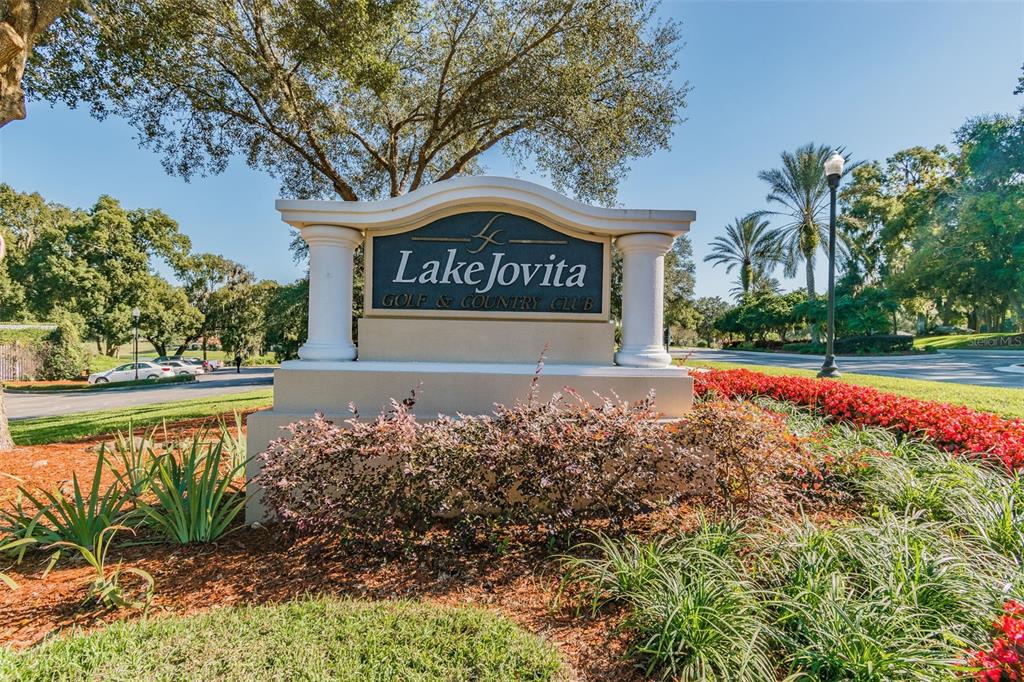 A stone monument sign for Lake Jovita Golf & Country Club sits in a landscaped garden — 12442 FOREST HIGHLANDS DRIVE, DADE CITY, FL