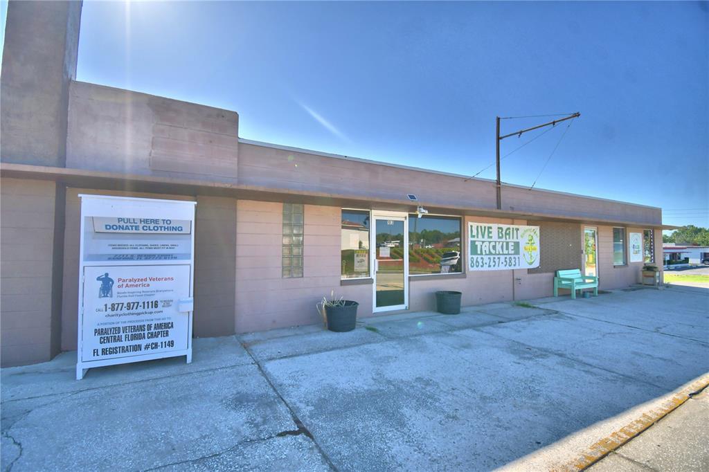 A single-story commercial building with a donation sign and a live bait and tackle shop — 105 S SCENIC HIGHWAY, FROSTPROOF, FL