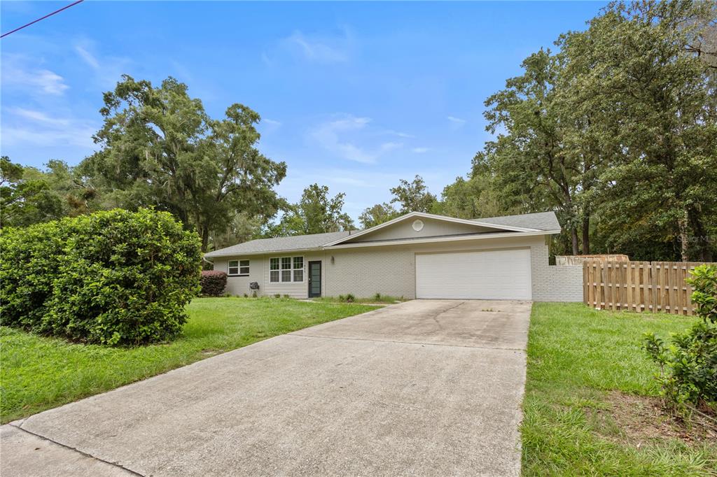 A single-story brick house with a white garage door and a concrete driveway — 805 NW 40TH TERRACE, GAINESVILLE, FL