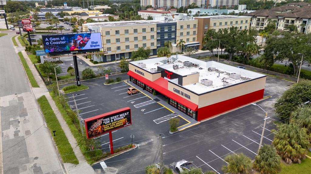 An aerial view shows a restaurant building with a red and beige exterior and parking — 6071 W IRLO BRONSON MEMORIAL HIGHWAY, KISSIMMEE, FL