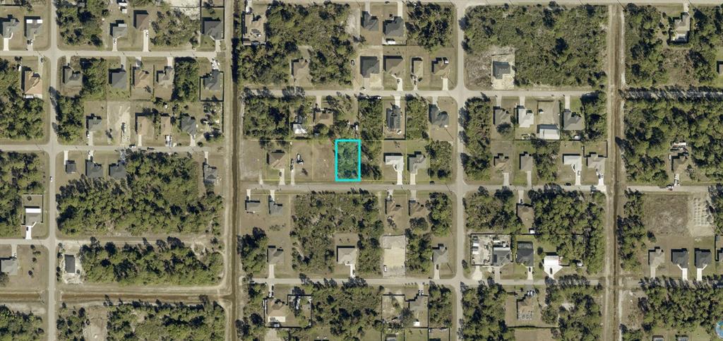 This is an aerial map view of a vacant residential lot highlighted in blue — 3008 40TH STREET W, LEHIGH ACRES, FL