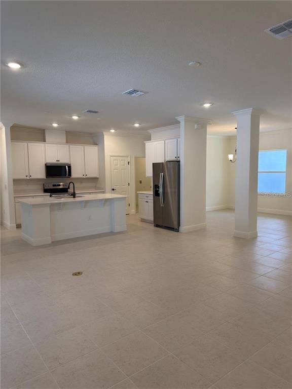 A kitchen with white cabinets, stainless steel appliances, and a central island with a sink — 8925 N GOLFVIEW DRIVE, CITRUS SPRINGS, FL